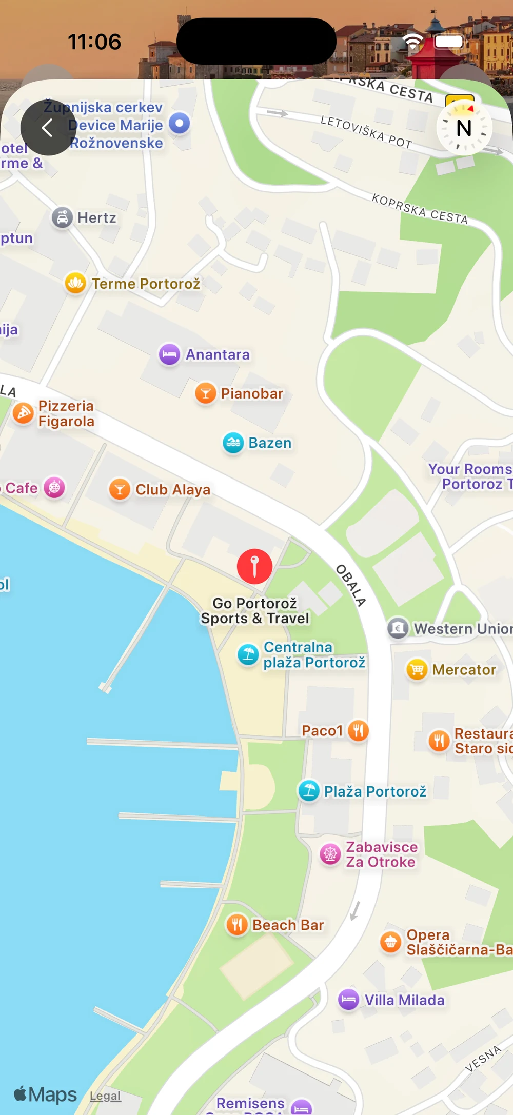 Funkie iOS app full-screen map view with red pin marker showing an activity location, surrounding streets, Slovenian city context, back button top-left.